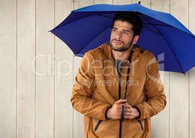 Man against wood with umbrella