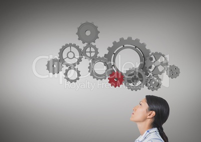 woman lookingup at cog wheels