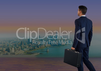 Businessman holding briefcase over city