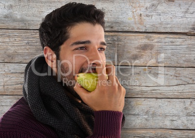 Man against wood with pear and scarf