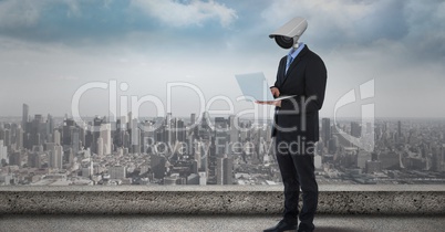 Businessman with CCTV head with city skyline