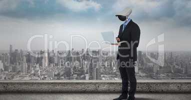 Businessman with CCTV head with city skyline