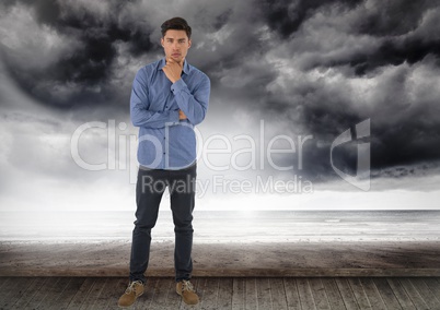 Businessman standing in pose by dark sea