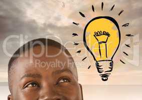 man looking up at light bulb idea