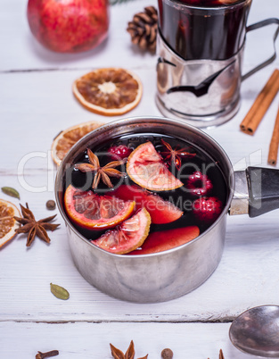 cooked mulled wine in an aluminum container