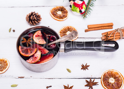 cooked mulled wine in an aluminum pan