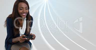 Businesswoman playing with computer game controller with bright curved background