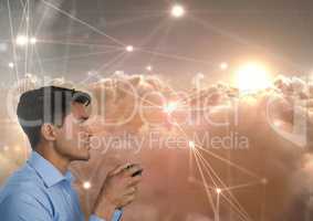 Businessman playing with computer game controller with line light connections in clouds background