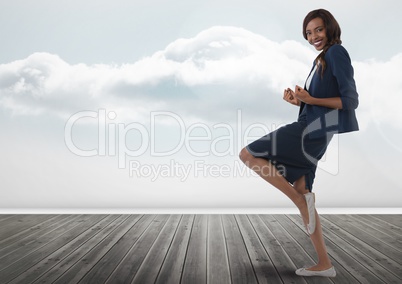 Businesswoman standing on one leg with clouds
