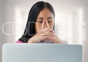 Businesswoman with laptop at desk with bright background