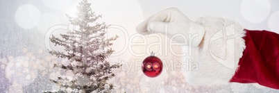 Santa with Winter landscape holding decoration bauble