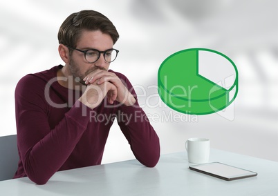 Businessman with tablet at desk with pie chart diagram