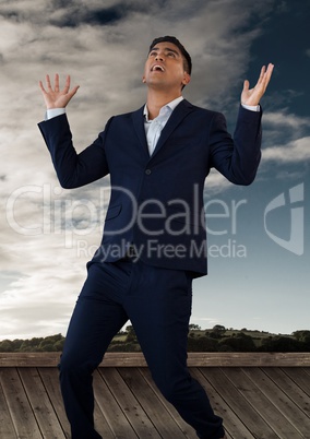 Businessman with hands out bewildered to the sky