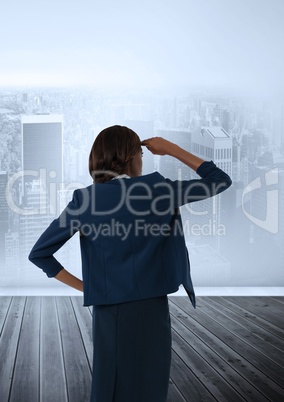 Businesswoman in room looking over city