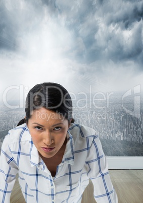 Businesswoman in front of city with determined face