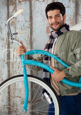 Man against wood with bicycle and warm scarf
