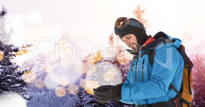 man skiing on slope putting on gloves