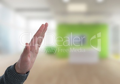 Hand interacting raised with bright office background