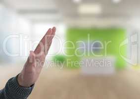 Hand interacting raised with bright office background
