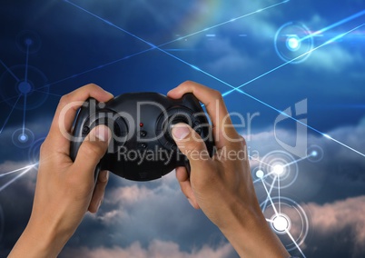 Hands playing with computer game controller