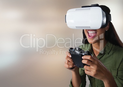 woman playing with computer game controller and Virtual reality headset with bright blurred backgrou