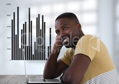 Businessman at desk with laptop and bar charts statistics