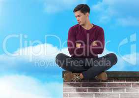 Businessman sitting on brick wall