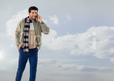 Businessman on phone with clouds and scarf