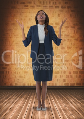 Businesswoman with arms open hopefully in room