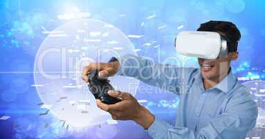 Businessman playing with computer game controller with virtual reality headset with technology backg