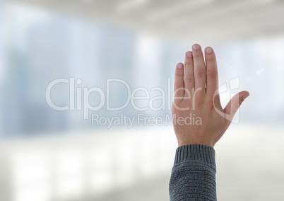 Hand open waving with bright windows in office