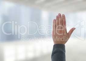 Hand open waving with bright windows in office