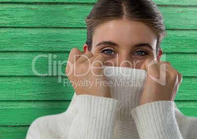 Woman against wood with warm jumper