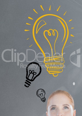 woman looking up at light bulb