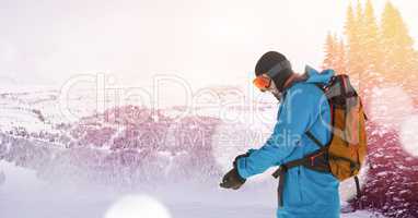 man skiing on slope putting on glove