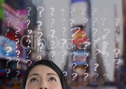 woman looking up at question marks