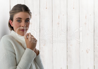 Woman against wood with warm jumper