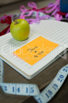Diary with new year resolution join a gym and measuring tape