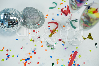 Mirror ball with silver hat, decorations and glass on white background