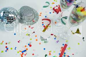 Mirror ball with silver hat, decorations and glass on white background