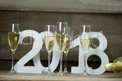 Champagne glasses surrounded against numbers forming 2018 year