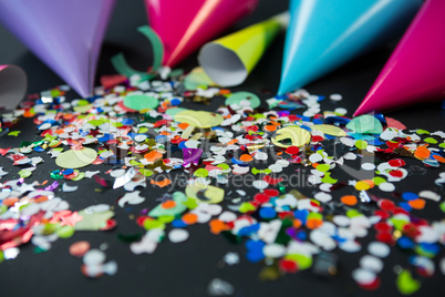 Party hat with confetti on black background