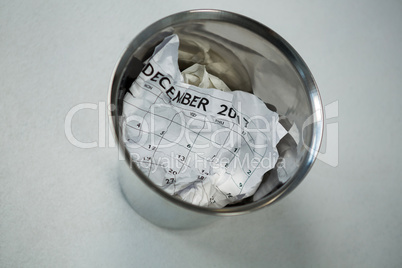 Crumpled calendar in dustbin