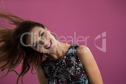 Smiling woman tossing her long hair