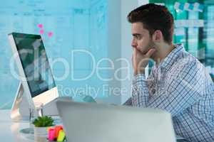 Male executive working on personal computer at desk