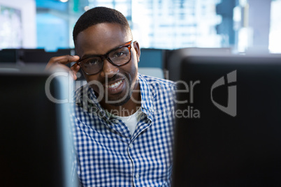 Portrait of computer engineer sitting at desk