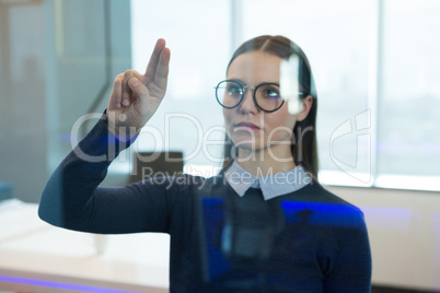 Female executive touching digital screen