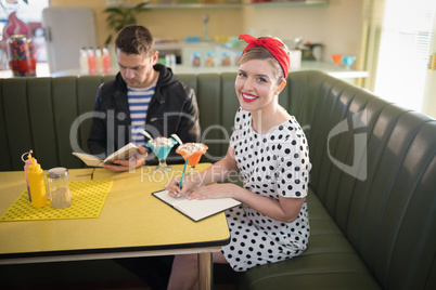 Couple looking at menu in restaurant