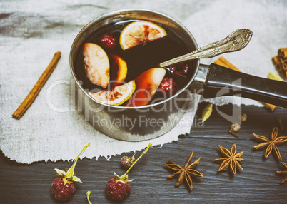 mulled wine in an aluminum ladle
