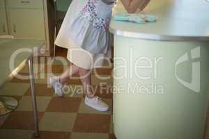 Waitress leaning at counter in restaurant